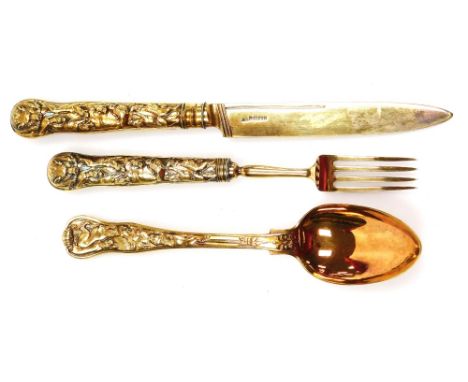 A George IV silver gilt three piece cutlery set, each heavily embossed with dogs, boars, hunting scenes, arrows and Medusa fi