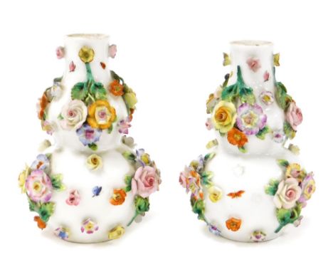 A pair of late 19thC Dresden double gourd bud vases, each with applied floral decoration and painted butterflies, with two bl