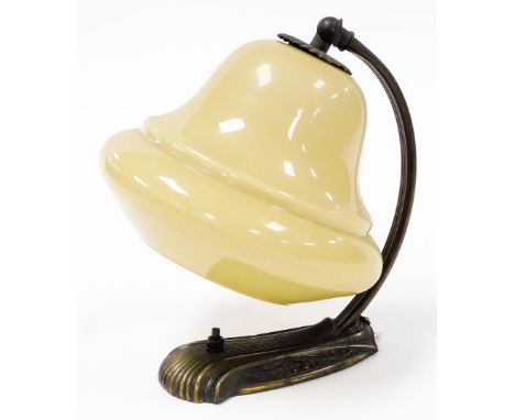 A 1960s/70s desk lamp, the arched brass finish frame, with a yellow domed glass shade, 25cm high.