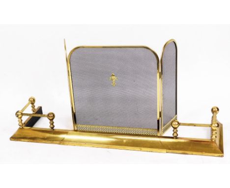 A large brass fire surround, with ball and claw design ends, 130cm wide, together with a three fold fireguard. (2)