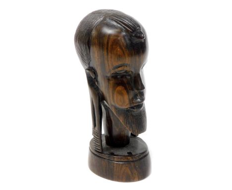 Tribal Art. A late 20thC carved wooden figure of an African head, on shaped base, 18cm high. 