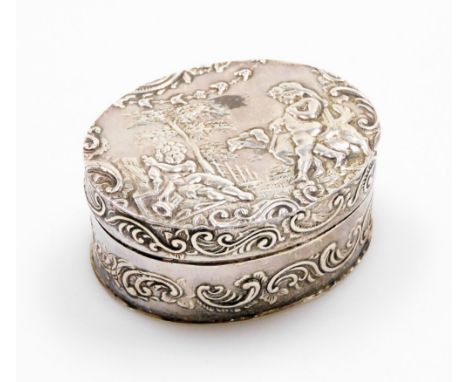 A Continental snuff box, of oval design with embossed decoration of cherubs, leaves and scrolls, white metal stamped 930, 5cm