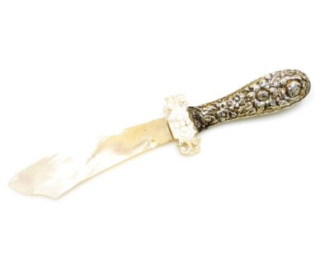An early 20thC mother of pearl letter opener, the mother of pearl laden finial with floral decoration, on a white metal flora