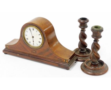 An Edwardian inlaid mahogany mantel clock, with timepiece movement 31cm wide, and a pair of dwarf barley twist candlesticks. 