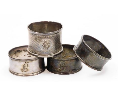 Four silver napkin rings, two bearing the initial F, another unmarked and another with engine turned decoration, with circula