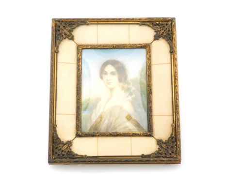 An early 19thC portrait miniature of a lady, the half length portrait of lady in white evening dress with applied golden jewe