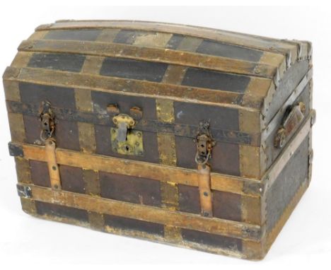 An early 20thC dome topped cabin trunk, with mahogany splats and brass hinges, opening to reveal a white papier mache interio
