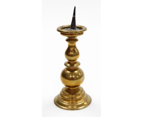 A late 19thC brass pricket altar candlestick, on bulbous and stepped base, 29cm high.