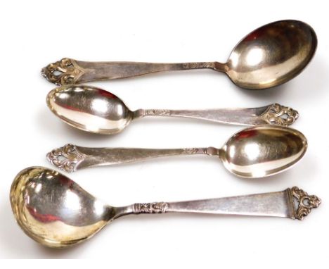 Four Norwegian spoons, three of similar design, with pierced scroll carved ends, and embossed reeds, one large and two small,