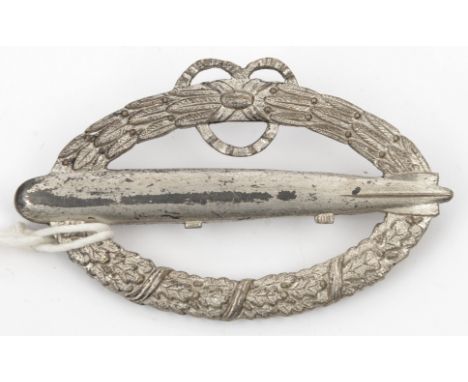 A post WWI German commemorative Army airship crew badge, of silver plated white metal, the reverse engraved “Fur Verdienste L