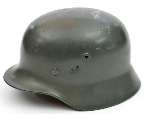 A Third Reich M40 steel helmet,  with smooth grey painted finish and no decals, the inner rim with maker’s mark “Q” (Quist), 