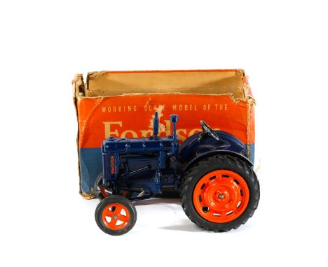 A scarce Chad Valley Fordson Major Tractor. In dark blue with orange wheels fitted with rubber tyres. Complete with steering 