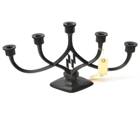 A Third Reich SS 5 branch candlestick, of blackened cast iron with entwined stems of diamond section, octagonal scones and SS