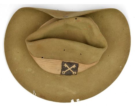 A WWII slouch hat, with khaki puggaree bearing 14th Army and 2nd Division patches, sweatband marked “Hall and Phillips Ltd 19