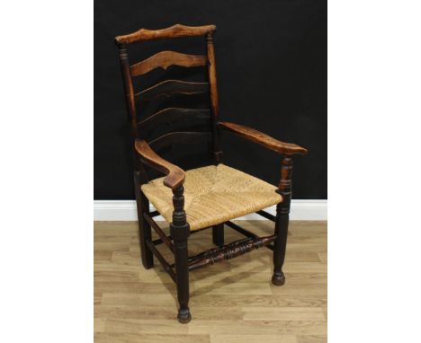 A 19th century elm ladder back armchair, shaped cresting rail, outswept arms, rush seat, turned legs and stretchers, pad feet