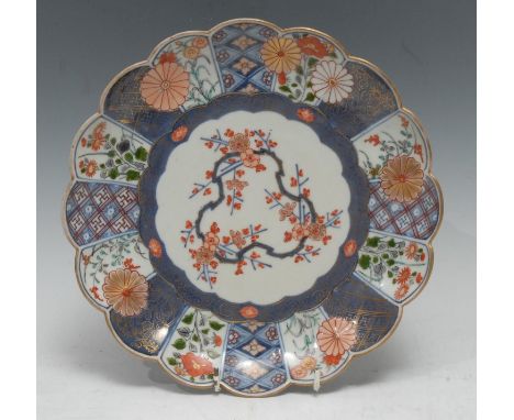 An early 18th century Japanese porcelain Mosaic pattern shaped circular plate, the powder blue chrysanthemum field picked out