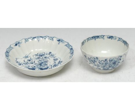 A Worcester breakfast faceted teabowl and saucer,  painted in blue underglaze with a bird, trailing shrub and hollow rock, cr