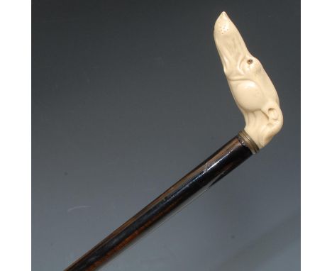 A late 19th century gentleman's novelty walking stick, the ivorine handle as a greyhound, two-tone hardwood shaft, brass walk