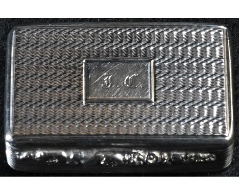 A William IV silver rounded rectangular vinaigrette, engine turned overall, hinged cover with foliate thumbpiece, centred by 