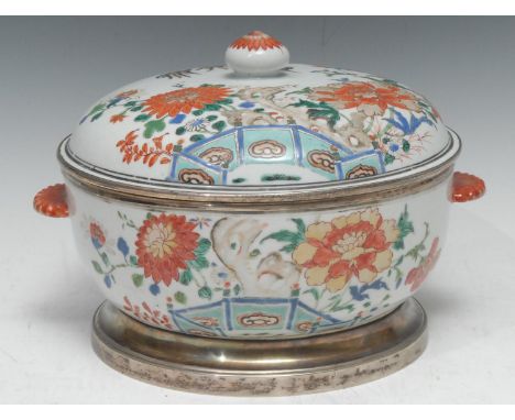 A 18th century Chinese two handled tureen and cover, decorated in polychrome with lotus, foliage and fence, slightly domed co