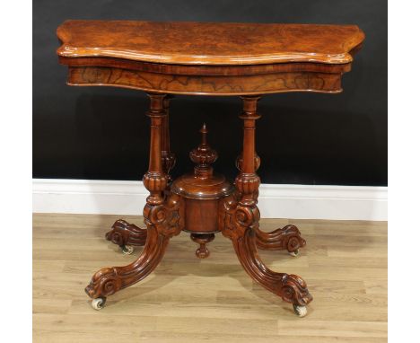 A Victorian burr walnut serpentine card table, folding top with matched veneers enclosing a baize lined playing surface, quat