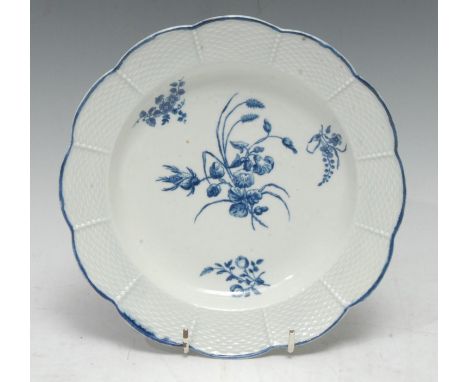 A Worcester shaped circular plate,  basket weave moulded border, decorated in under glaze blue with country flowers, 20cm dia