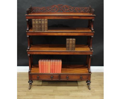 A Victorian walnut open bookcase, three-quarter fretwork gallery pierced with leafy scrolls, above four tiers flanked by spin