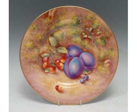 A Royal Worcester circular plate,  painted by John Freeman, signed,  with plums and cherries on a mossy bank, 26.5cm diam, pr