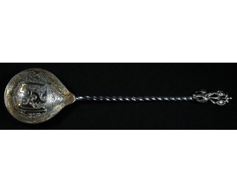 An Ottomon Turkish silver spoon, the gilt bowl engraved with Islamic script, twisted stem with bird finial, 24.5cm long, c.19