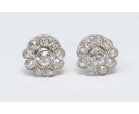 A pair of diamond floral cluster earrings, each with a central round brilliant cut diamond approx 0.92ct, surrounded by a ban