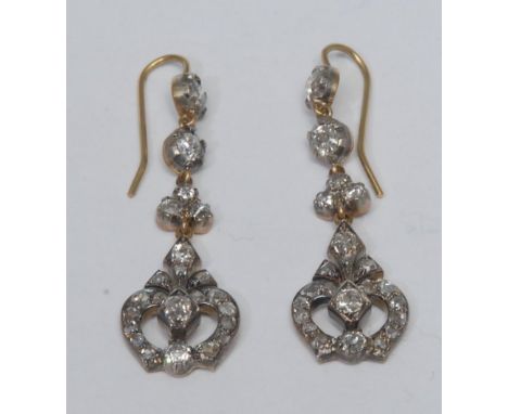 A pair of Art Deco style diamond pendant drop earrings, shaped trident heart droplets encrusted with forty six old cut diamon