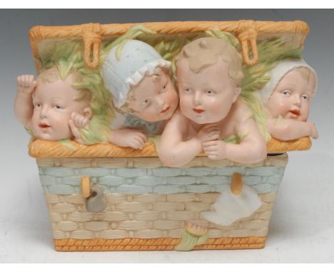 A Gebruder Heubach bisque table box and cover, modelled as an open wicker basket with four mischievous babies peeping out, 23