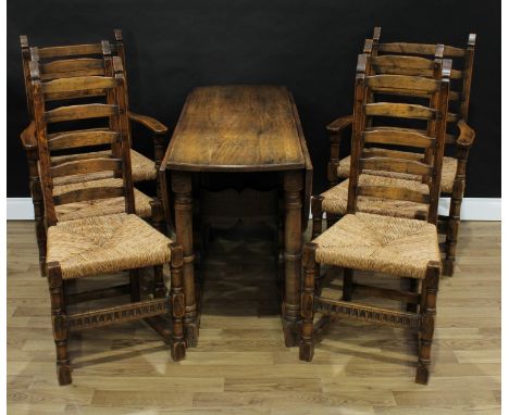 An 18th century style oak gateleg dining table, oval top, the underframe with shaped end supports, cannon-barrel legs and unu