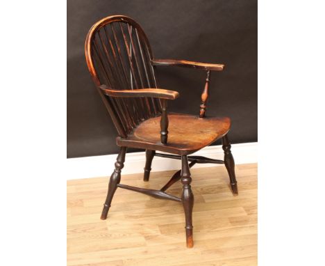 A 19th century elm and ash Windsor elbow chair, arched stick back, serpentine arms, saddle seat, turned legs, H-stretcher, 91