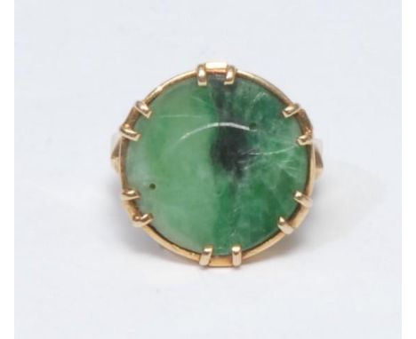 A carved jade panel ring, circular green and black lined panel, carved with a Mouse beneath Corn Sheaf, collar set within a 1