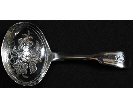 A George IV silver fiddle pattern caddy spoon, the oval bowl bright-cut engraved with ribbon-tied flowers outlined with wrigg