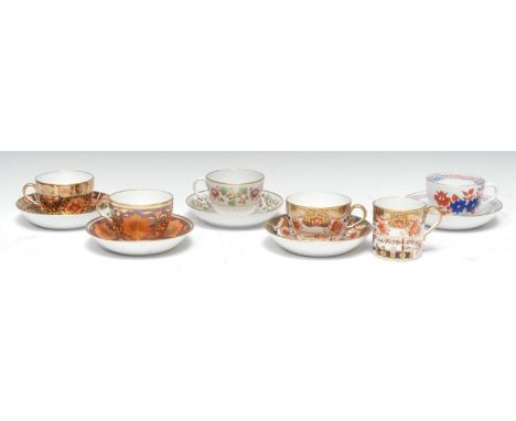 A Spode Bute shaped teacup and saucers, decorated with large orange flowerheads and foliage on a mauve ground, picked out in 