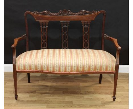 An Edwardian inlaid mahogany salon sofa, carved and pierced three panel back, tapering supports, 120cm wide 