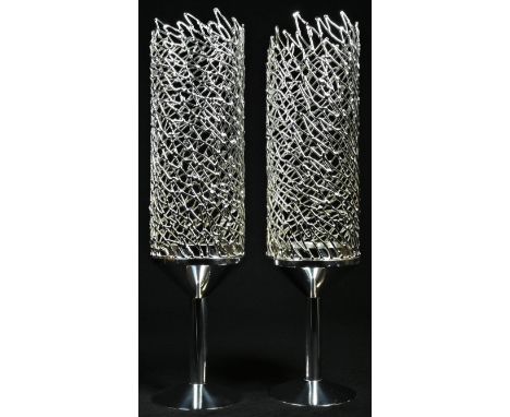 Stuart Devlin (1931 - 2018) - a pair of Elizabeth II silver candlesticks, textured filigree shades, spreading circular bases,