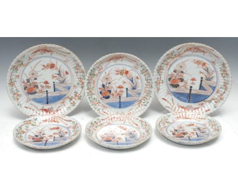 A pair of Chinese Imari fluted circular plates, painted with fence and flowers, 26.5cm diam, c.1790;  another, 23.5cm diam;  