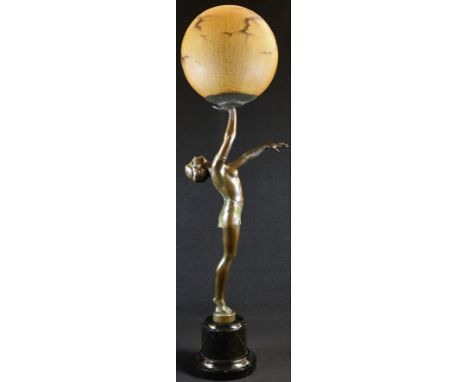 An Art Deco design verdigris patinated figural table lamp, as a scantily clad young lady balancing a ball, globular shade, ma