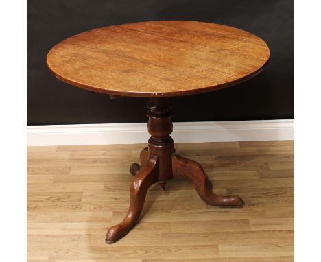 A George III oak tripod occasional table, circular tilting top, turned pillar, cabriole legs, pad feet, 73cm high, 89cm wide,