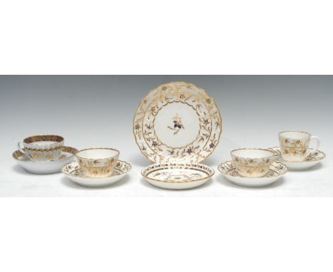 A Worcester coffee cup, tea bowl and saucer, decorated in gilt with stylised foliage in gilt with cobalt blue berries, cresce