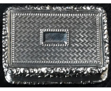A George IV silver rounded rectangular vinaigrette, engine turned and applied with leafy borders, hinged cover centred by a v