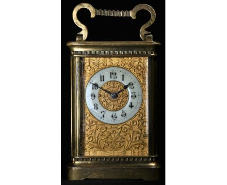A late 19th century French lacquered brass carriage timepiece, 5cm dial with enamel chapter of Arabic numerals, on a gilt gro