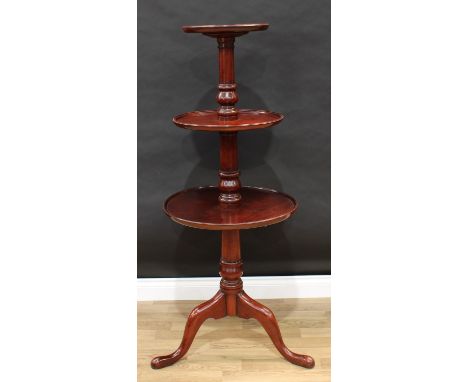 A George III style mahogany three-tier dumbwaiter, circular dished graduated plateaux, turned pillar, cabriole legs, pad feet