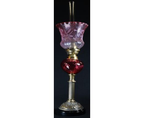 A cranberry glass and brass table oil lamp, Gaudard adjustable burner, the frilled shade frosted and etched with butterflies 