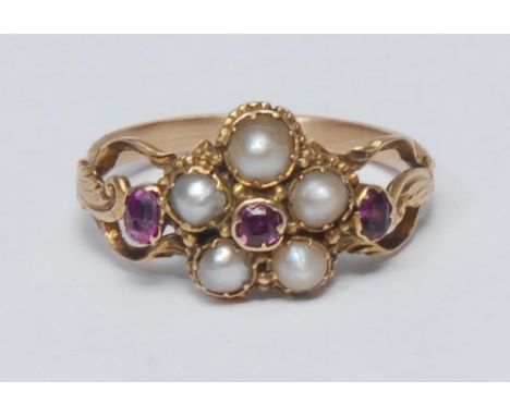 An 18th century style pearl and ruby floral cluster ring, five mabe pearls surrounding a central deep red old cut ruby, flank
