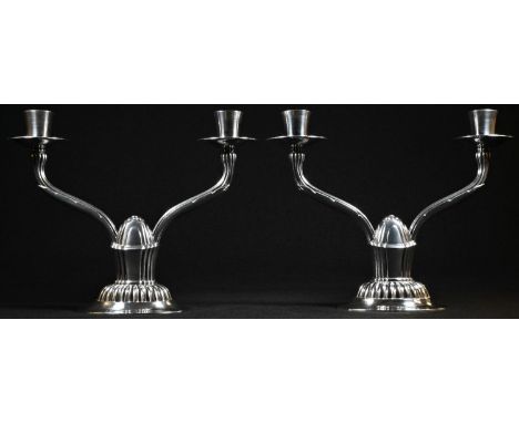 Robert Edgar Stone - a pair of Arts and Crafts style silver two-light candelabra, plain bell shaped sconces, reeded branches,