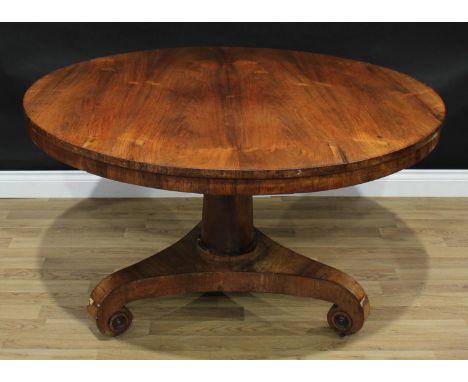 A George/William IV rosewood circular centre table, tilting top, columnar pillar, incurve canted triform base, scroll feet ap